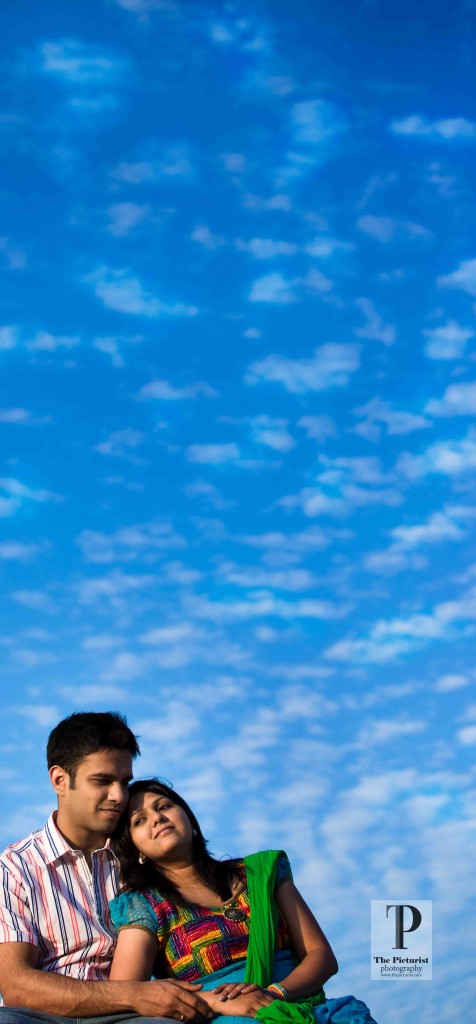 couple under the deep blue sky and fluffy clouds