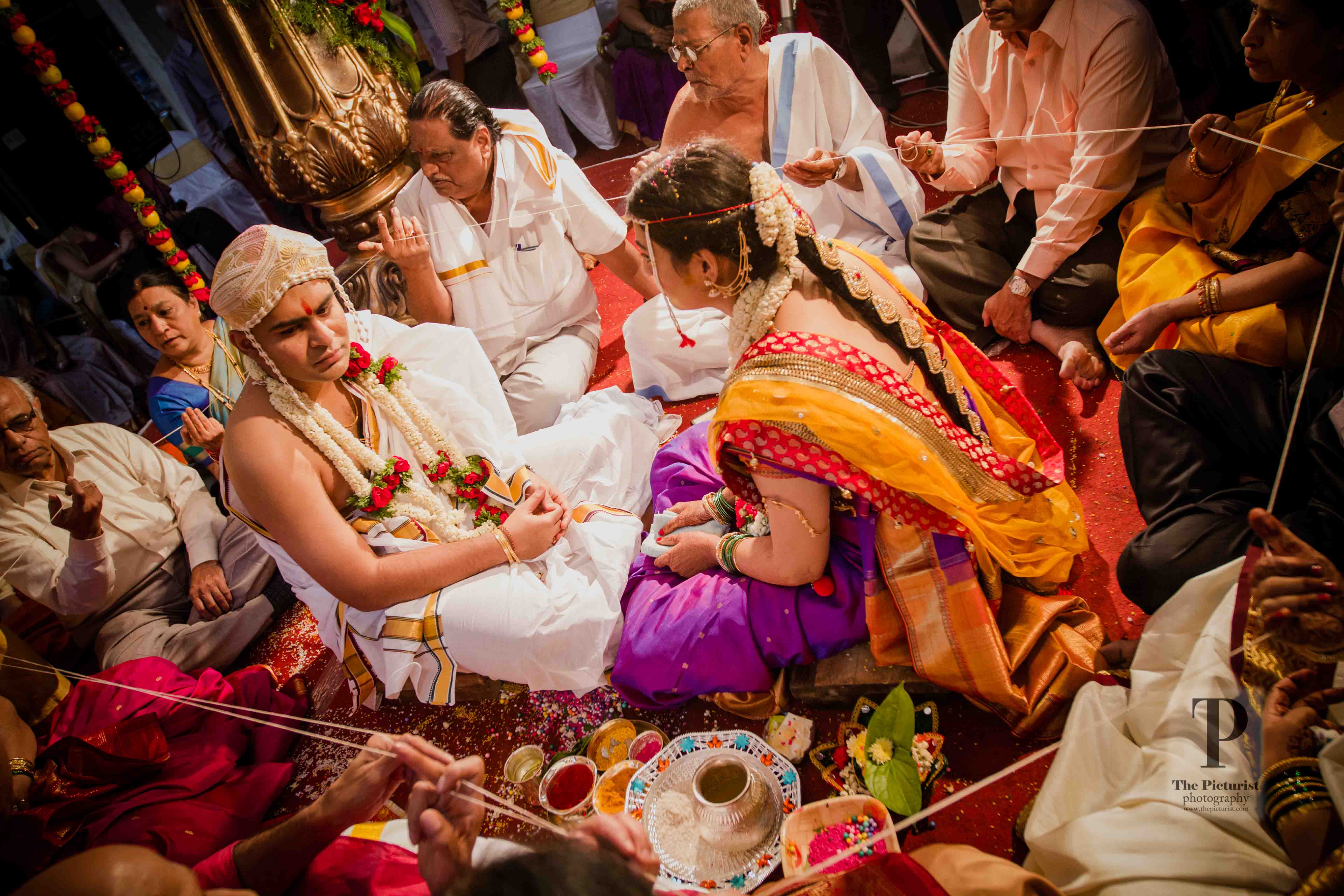 sacred thread is taken around the couple as though to create a protective boundary around them.