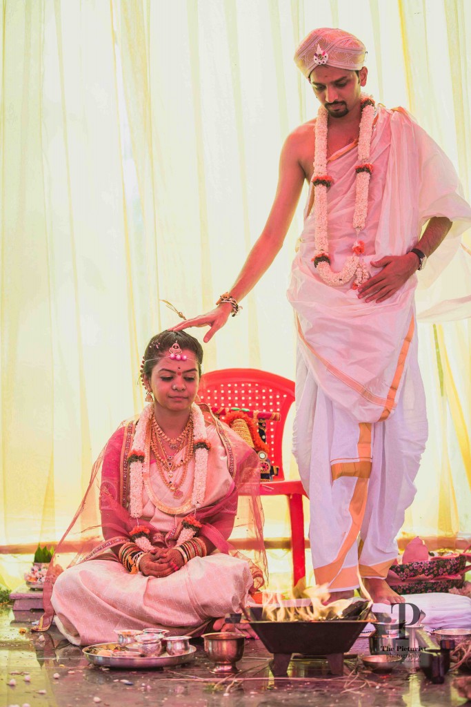 Bride and groom performing the post wedding rituals