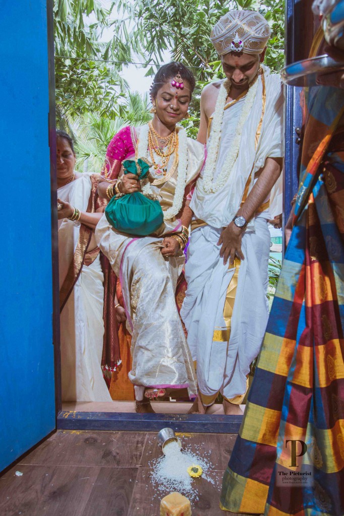 Tharunya pushes the rice bown as she enters the room. A symbolic grahpravesh