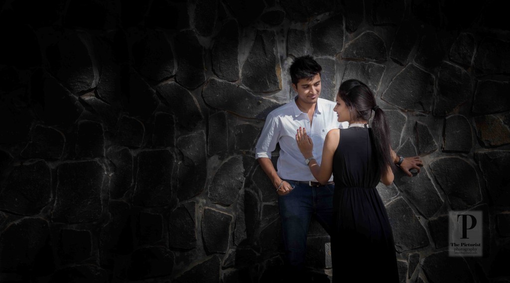 couple against a stone wall