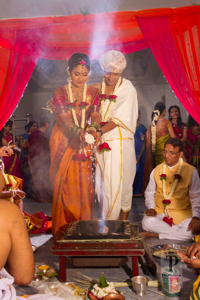 bride and groom make offerings to the sacred fire